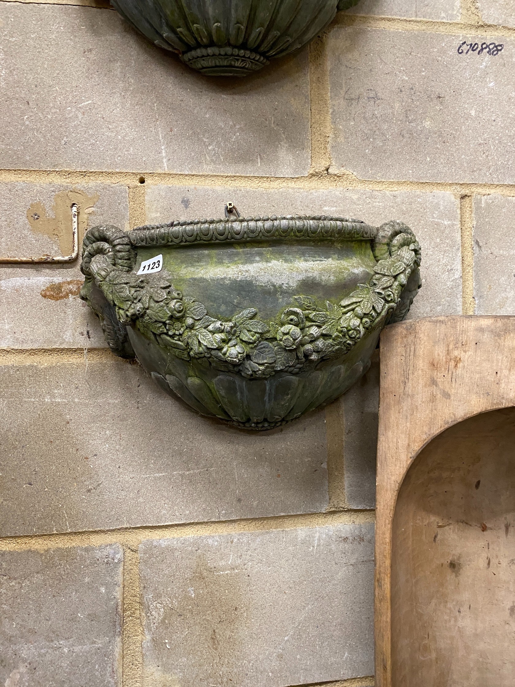 A pair of reconstituted stone garden wall planters, width 45cm, height 24cm